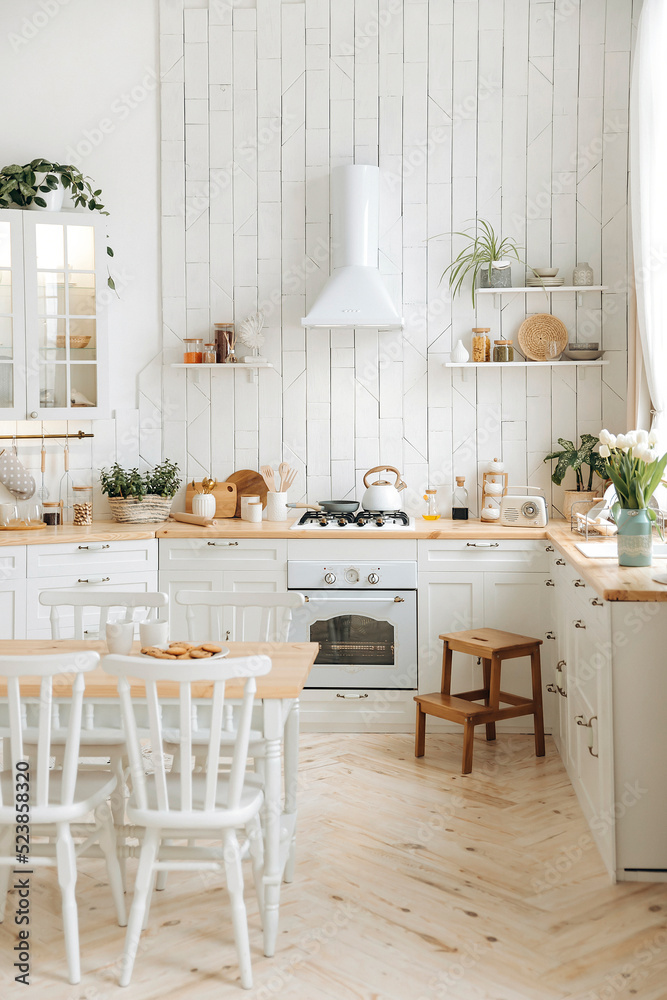 Modern white Scandinavian style kitchen with wooden worktop filled with ...
