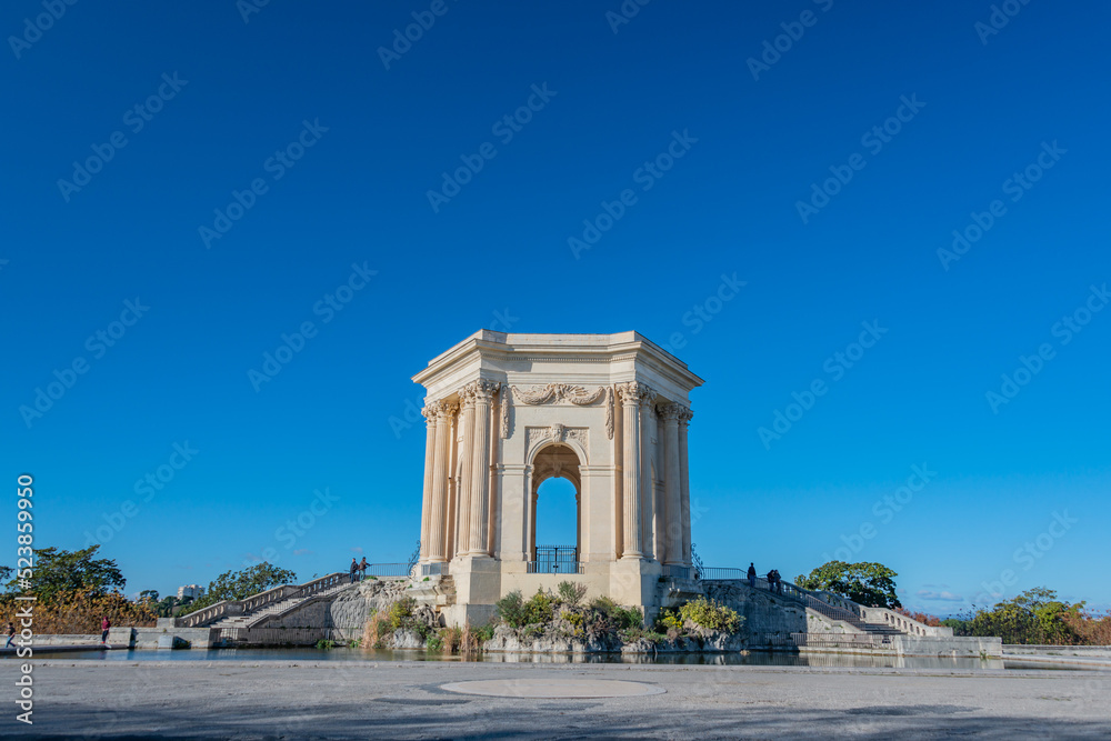 triumphal arch and fountain in Montpellier france park in autum with clear sky royal park of Louis XIV