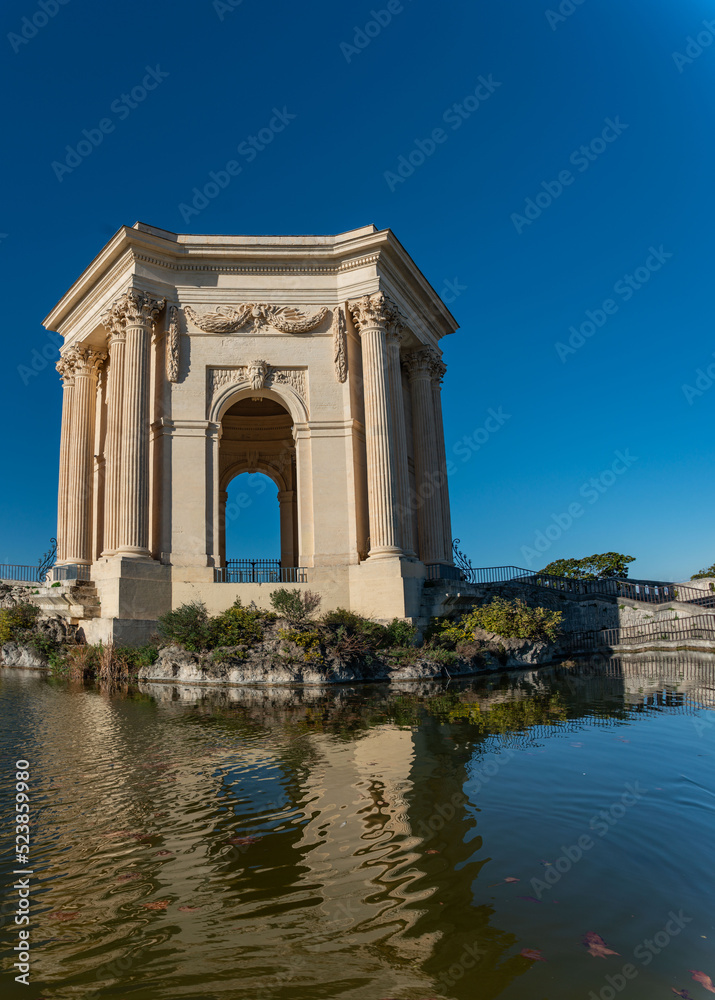 triumphal arch and fountain in Montpellier france park in autum with clear sky royal park of Louis XIV triumphal arch and fountain in Montpellier france park in autum with clear sky royal park of Louis XIV