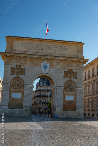 street and triumph arch in montpelier france with french flag