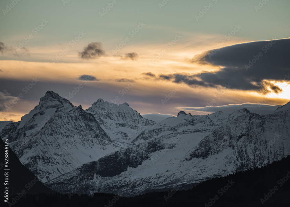 Sunset in the Norwegian snowy mountains and fjords