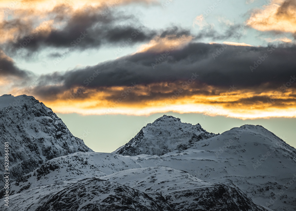 Sunset in the Norwegian snowy mountains and fjords