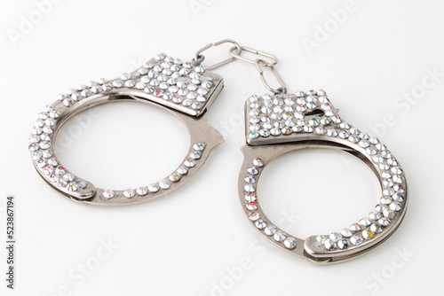 Handcuffs with jewelry, sex toy isolated on white background