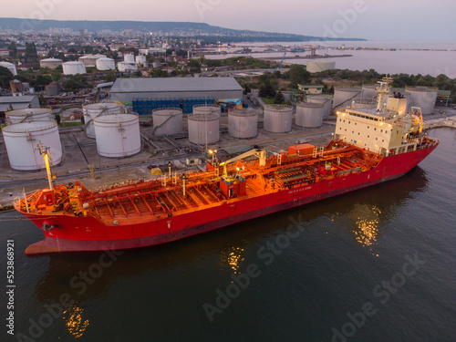 Aerial view of oil ship tanker and lpg ship at industrial port at sunset photo
