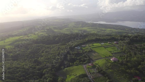 Toma aérea del parque eólico (eólicas) de Tilarán de Guanacaste Costa Rica con el lago Arenal de fondo en el atardecer de un día soleado photo