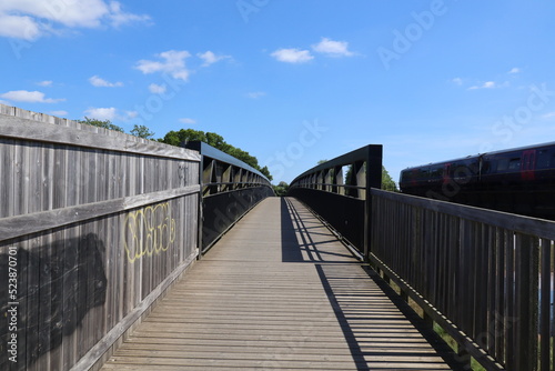A metal bridge running over the bird sanctuary on the River Exe near Topsham in Devon, England © Anthony