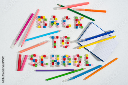 Composition of number beads forming words Back To School pencils, notebook, crayon, felt-tip pens.