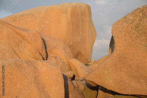 Extraordinarily beautifully colored stones and fantastically shaped rock formations weathered by centuries of wind and tide-pink granite coast in Brittany, France, close up, nature texture, background