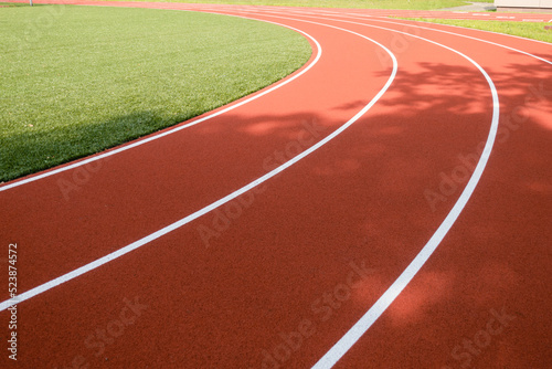 School sports stadium with red artificial rubber ground running tracks white lines on it