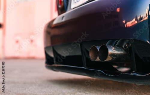 Twin tip exhaust pipe coming through the rear diffuser on the back of a car