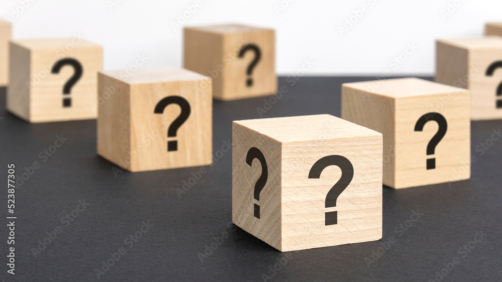 front view on many wood cubes with question marks. many question arising concept front view on many wood cubes with question marks. many question arising concept