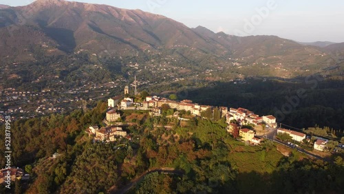 Fly Over liitle italian village, Pedona, on a mountain in toscany during sunset photo