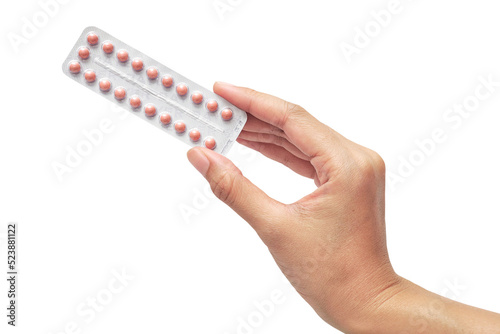 hand holding Oral contraceptive pill isolated on white background