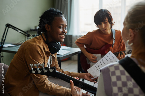 Photography Side view portrait of black young woman writing music with band and smiling happ