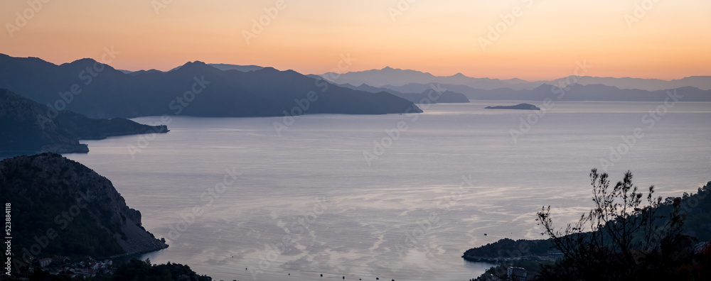 Landscape at sunrise overlooking the mediterranean sea and mountains. View of Turunk and Keci island. Turkey in summer, Marmaris area