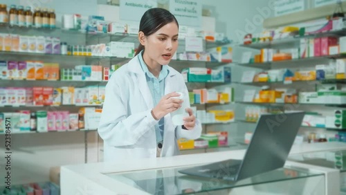 Wallpaper Mural Female pharmacist counseling customer via video call in a modern pharmacy drugstore. Torontodigital.ca