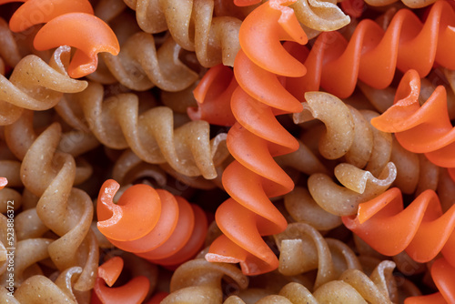 Whole, lentils fusilli pasta background.