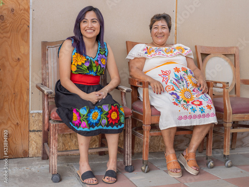 Portrait of an Indigenous woman and her daughter wearing tradtional clothing
