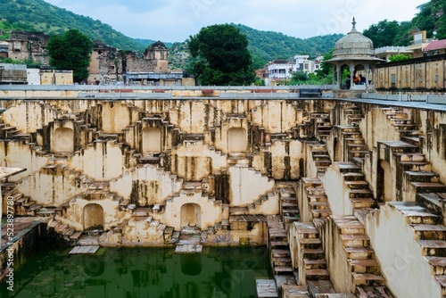 Beautiful shot of the Chand Baori or Abhaneri Step Well with reflection in the water,Rajasthan,India photo