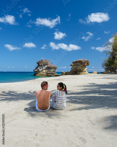 Anse Chastanet Beach St Lucia Caribbean Island, Tropical St Lucia, a couple walking at the white beach. Tropical beach in Saint Lucia, Asian women and caucasian men on the beach photo