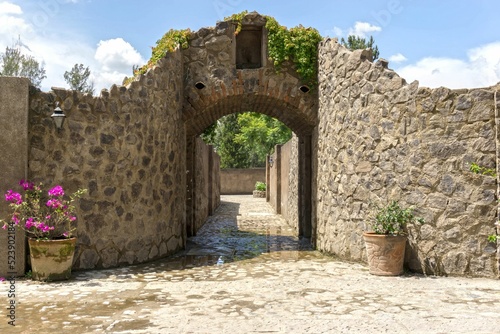 Beautiful stone wall with flower pots and a clear sky in the background photo