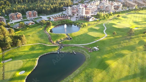 Aerial shot of the Piring Golf playground in Razlog Bulgaria with cars passing on the road photo