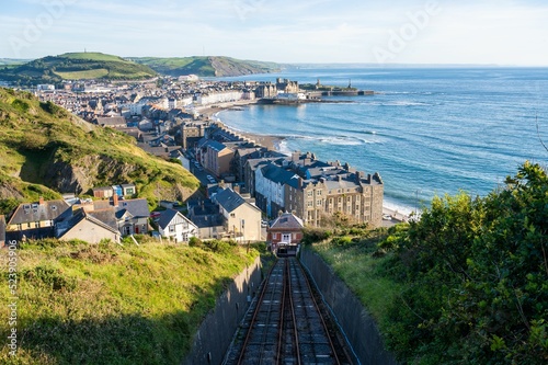 Railroad taking to Aberystwyth town of Wales with a view of the sea photo