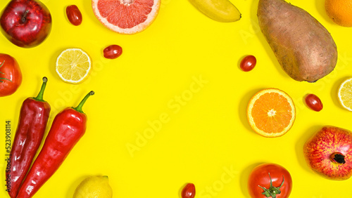 Fototapeta Naklejka Na Ścianę i Meble -  Creative copy space on yellow background with red fruits and vegetables. Flat lay