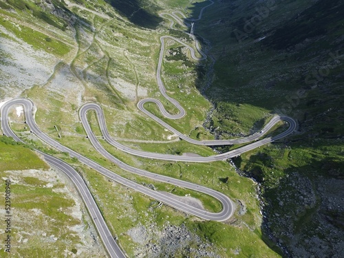 Aerial view of lovely switchback roads in a green mountainous area