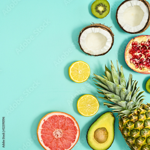 Fresh summer tropic fruitslayout on pastel cyan background. Flat lay