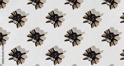 Pattern of delicious halloween spider cookies on white background. Top view. © Katecat