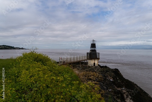 Battery Point Lighthouse in Somerset, England with the Woodhill Bay in the background photo