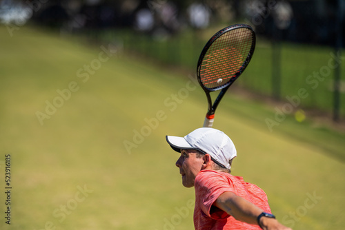 Tennis player hitting tennis balls in a tennis match on grass courts in a tournament 