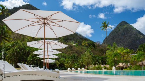 Sugar beach Saint Lucia, is a public white tropical beach with palm trees and luxury beach chairs on the beach of the Island St Lucia Caribbean. 