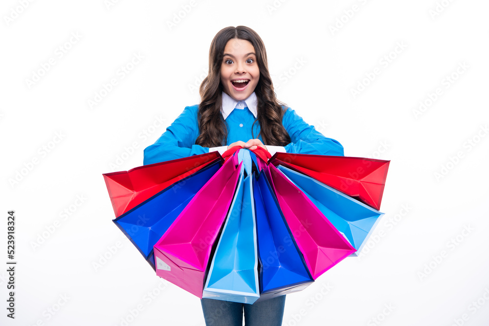 Girl teenager with shopping bags isolated on white backgound. Shopping and sale concept. Surprised emotions of young teenager girl.