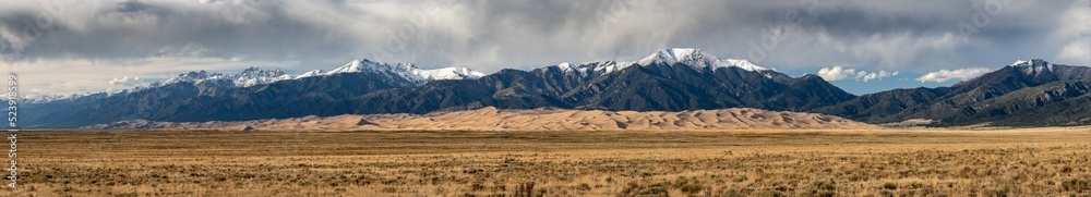 Panorama of Great Sand Dunes Below Snow Capped Mountains Panorama of Great Sand Dunes Below Snow Capped Mountains