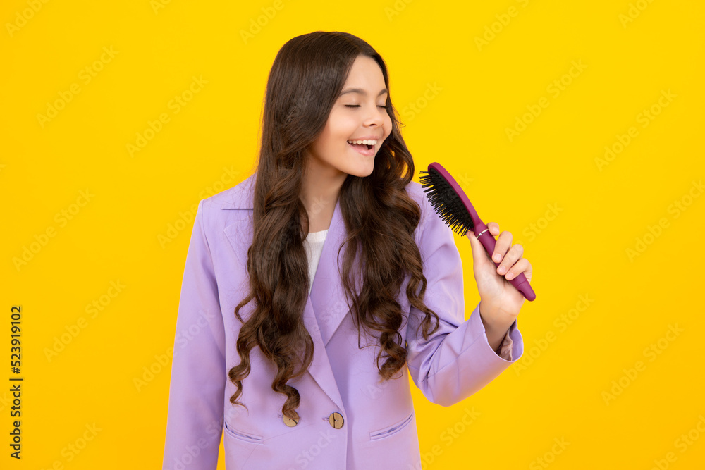 Teenager girl with long hair holding comb hairbrush for combing, beauty.  Conditioner shampoo hair. Beauty kids salon. Child hairstyle. Happy face,  positive and smiling emotions Stock Photo | Adobe Stock