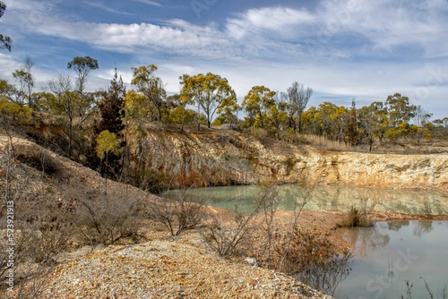 Mesmerizing view of the water with the reflection of rocks and trees at Emmaville, Australia photo