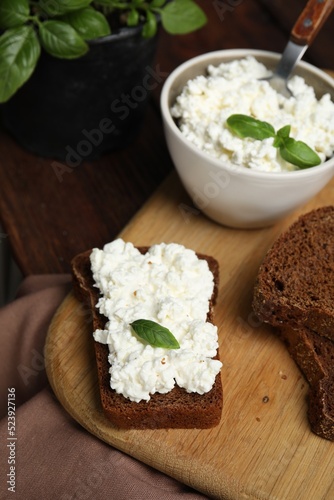 Bread with cottage cheese and basil on table