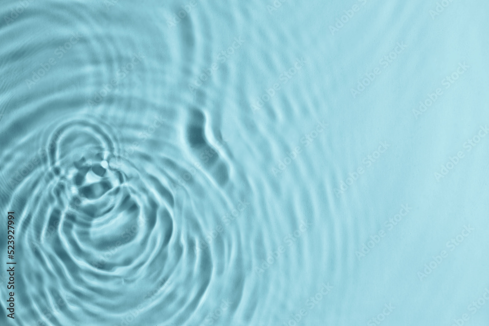 Fototapeta premium Closeup view of water with circles on turquoise background. Space for text