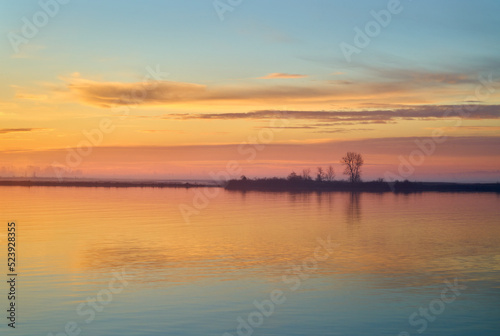 Calm Fraser River Sunrise. Quiet, early morning sunrise clouds on the Fraser River, British Columbia.    © maxdigi