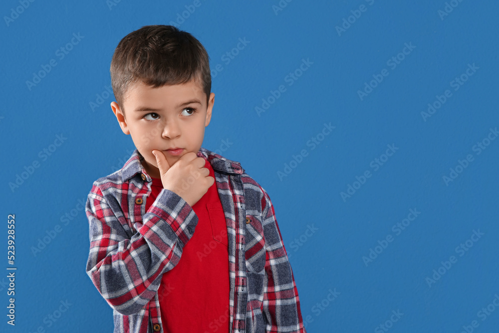 Thoughtful little boy on blue background, space for text Thoughtful little boy on blue background, space for text