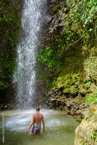Young men relaxing at Toraille waterfall St Lucia. Saint Lucia jungle waterfa...