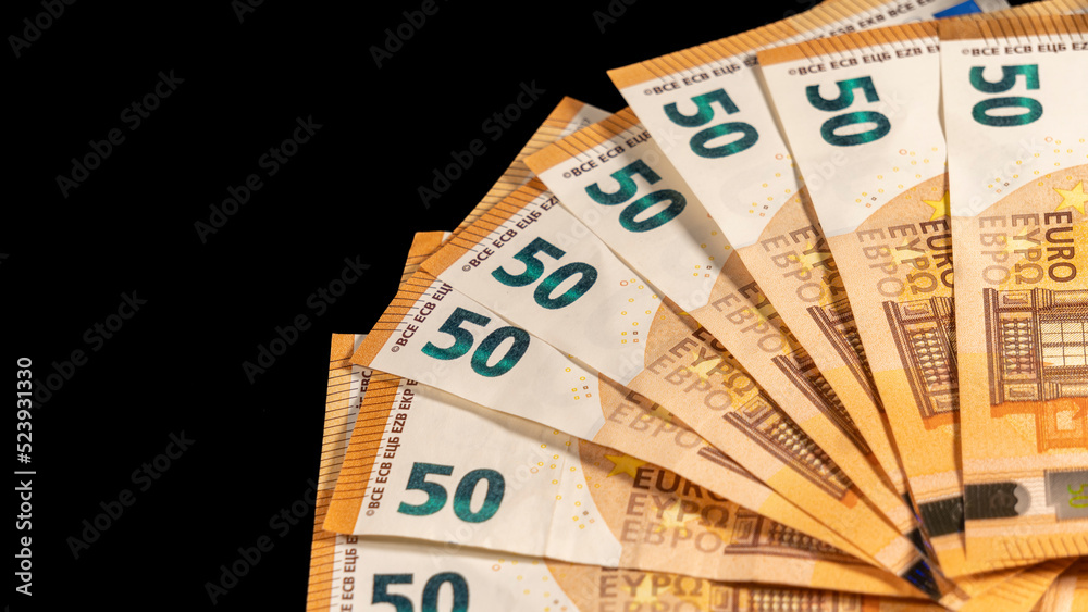 Fifty euro banknotes, arranged in a fan, on a black background Fifty euro banknotes, arranged in a fan, on a black background