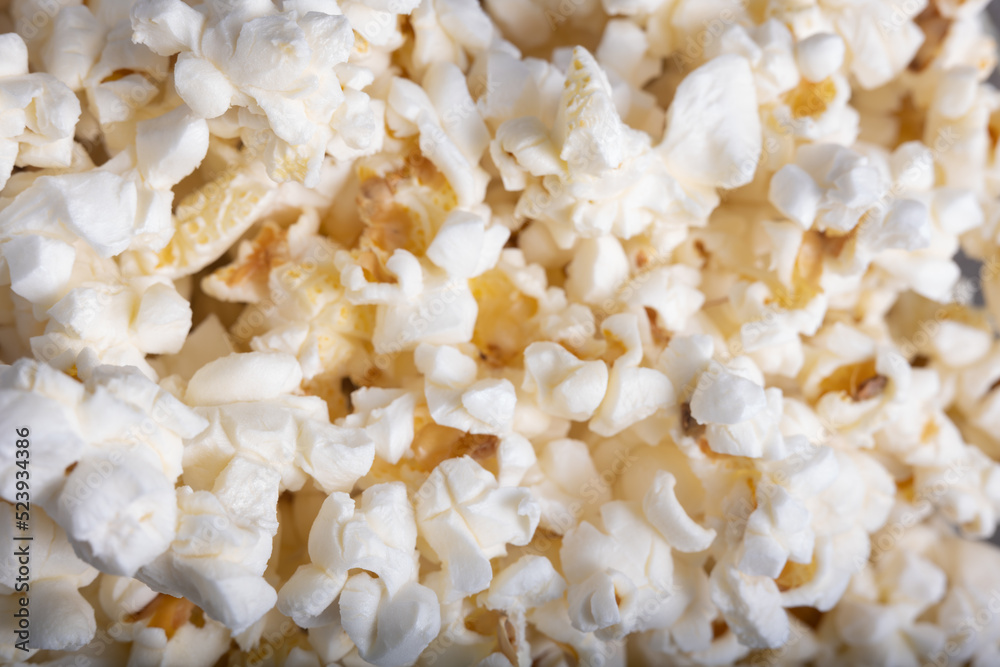 Overhead shot of lots of popcorn grouped together, a background of popcorn with butter and salt.