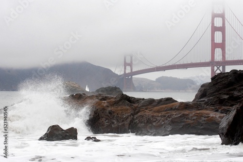 Baker beach in the fall with tide coming in and golden gate bridge photo