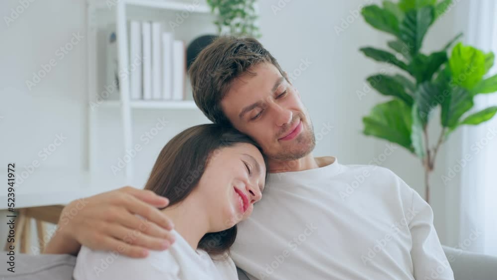 Caucasian young man and woman hug each other in living room at home. Caucasian young man and woman hug each other in living room at home.