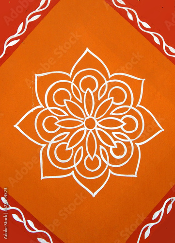 Indian Hindu traditional rangoli drawing on the wall of rural house