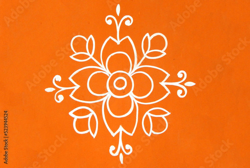 Indian Hindu traditional rangoli drawing on the wall of rural house