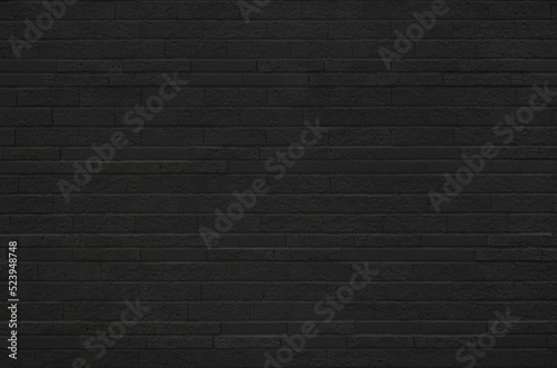 Black brick tile wall texture background. Vintage and modern exterior or interior backdrop design.